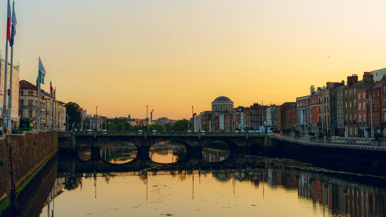 The River Liffey at sunset, looking towards Grattan Bridge and the dome of the Four Courts, Dublin